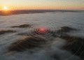 firefly gemini flash hyper realistic aerial view of gilroy and surrounding hills at sunrise, dramatic fog 797237
