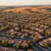 firefly gemini flash aerial view of gilroy suburban streets at golden hour, soft sunlight, warm natural co 841714