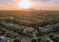 firefly gemini flash aerial view of a neighborhood at sunset, long warm shadows across rooftops, distant s 537013